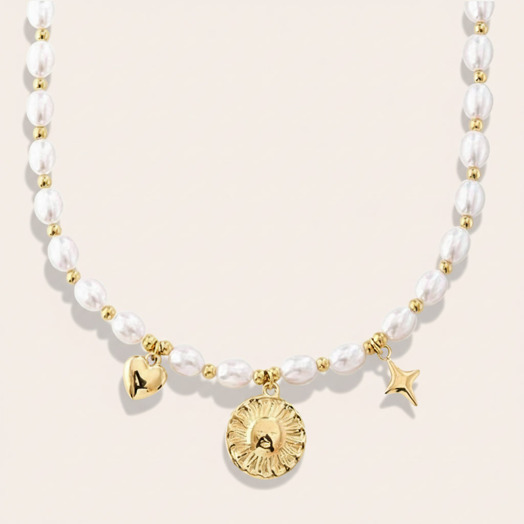 A gold necklace with white pearls, a heart-shaped charm, and a star-shaped charm.