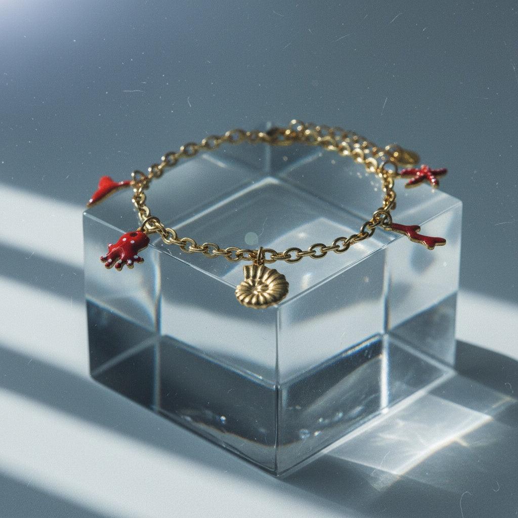 „Aquilea“ – Edelstahl-Arm­kette mit Meer-Charms, 17 cm + 3 cm