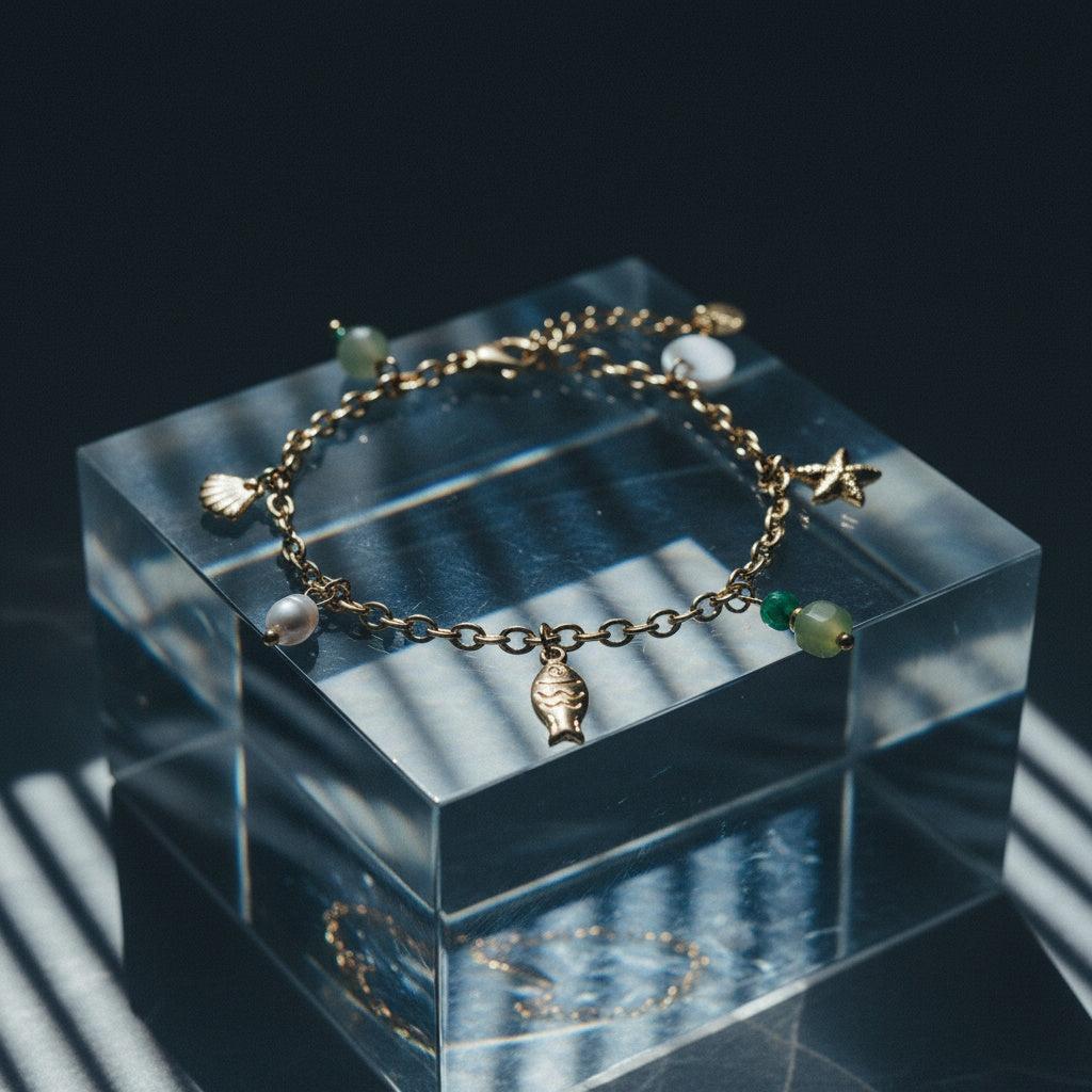 „Calypsi“ – Edelstahl-Arm­kette mit Süßwasserperlen & Meeres-Charms, 16 cm + 3 cm