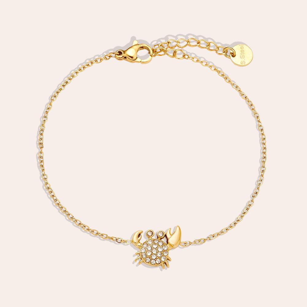 „Crilaya“ – Edelstahl-Arm­kette mit Zirkonia-Krabben-Charm, 17 cm + 3 cm-Goldharmonie