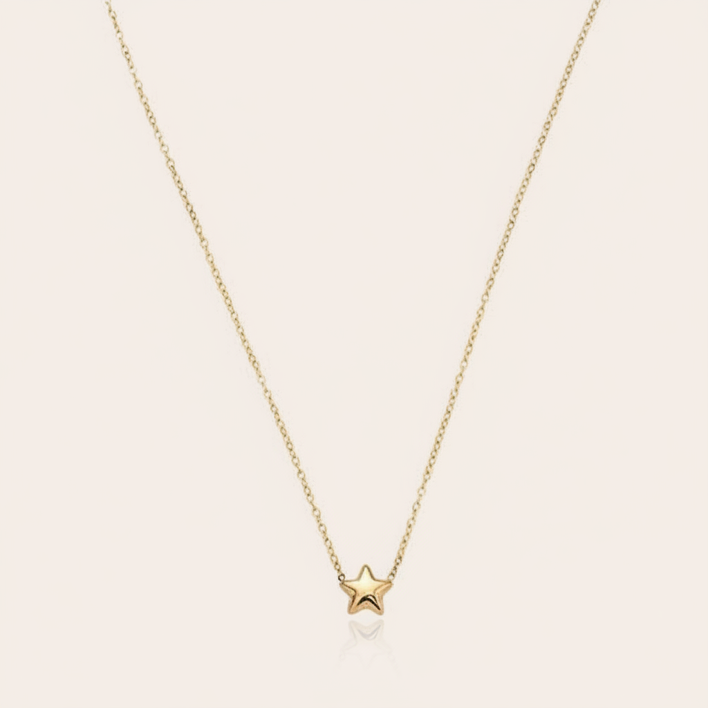 A delicate gold necklace with a small star pendant.